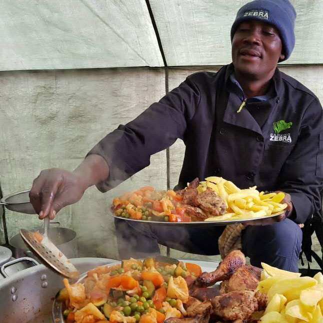 Barking Zebra chef serving delicious for on Mount Kilimanjaro