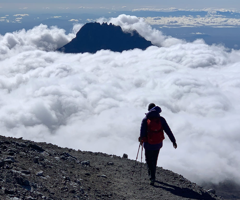 Climb Kilimanjaro For Charity Solo Climber Descending Summit