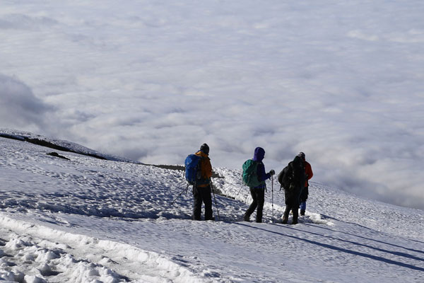 Climbers descend the summit after climbing Kilimanjaro