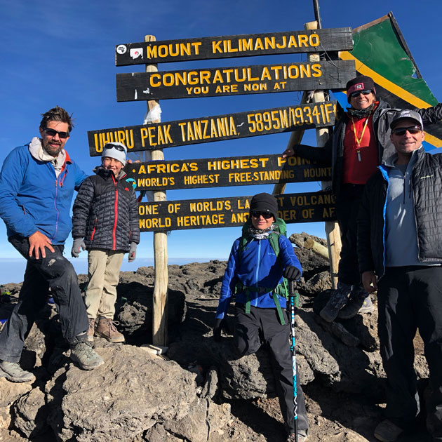 A celebration at the Mount Kilimanjaro summit from the Lemosho route