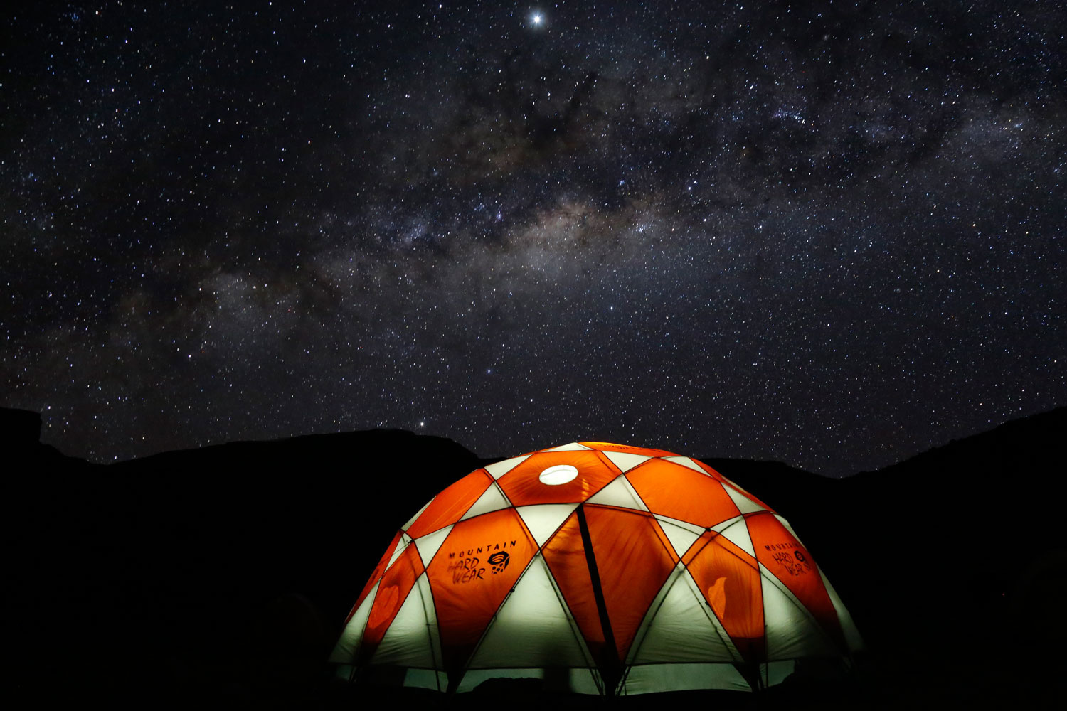 Glowing mess tent with the Milky Way in the background on the Northern Circuit Kilimanjaro